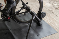 Cyclist doing a steady ride on the Saris MAG Trainer in a garage setup