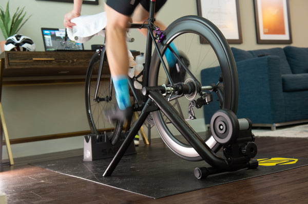 Saris MAG Bike Trainer in use — rider in race jersey, mid-session