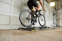 Cyclist balancing and pedaling on Saris 9501T Cycling Rollers — smooth stroke focus