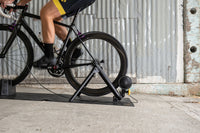 Cyclist doing intervals on the Saris MAG Plus Trainer — home training setup