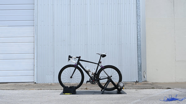 Cyclist warming up on the Saris Fluid 2 Smart Trainer in home training room