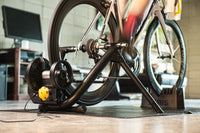 Rider on the Saris M2 Smart Trainer — early morning indoor cycling session