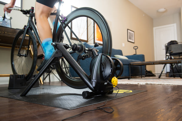 Cyclist in aerobars training on the Saris M2 Smart Trainer with virtual racing