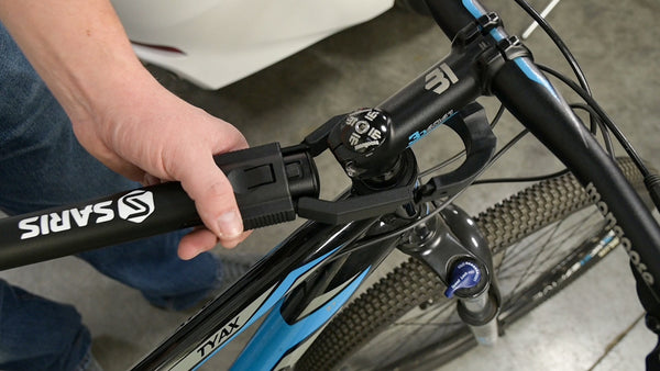 Saris Bike Beam — installation step showing clamp positioning on frame