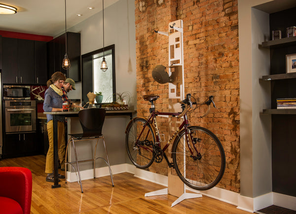 Couple storing bikes with the Saris Hottie Floor Stand in a home garage