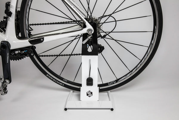 Saris Boss Rear Wheel Bike Stand — with road bike stored upright in jaw grip
