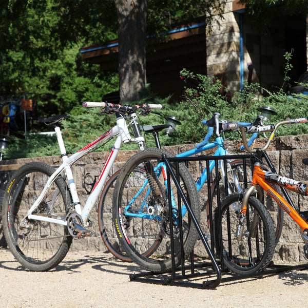 Saris Mighty Mite Bike Stand at outdoor event — road bike on display at trailhead