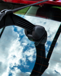 Car rearview mirror with a clear protective film on a reflective surface