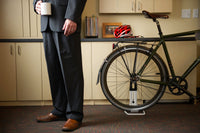 Saris Boss Rear Wheel Bike Stand holding a mountain bike — helmet hanging from handlebar