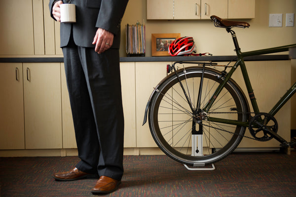Saris Boss Rear Wheel Bike Stand holding a mountain bike — helmet hanging from handlebar