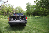 Mountain bike with thru-axle secured in Saris Traps fork-mount carrier — truck bed