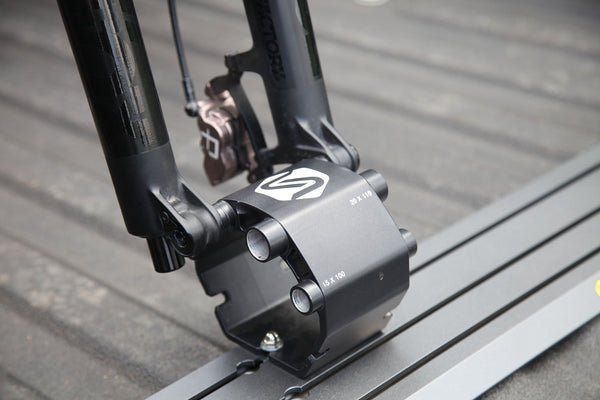 Saris Traps thru-axle fork mount — mountain bike secured in truck bed, trail access