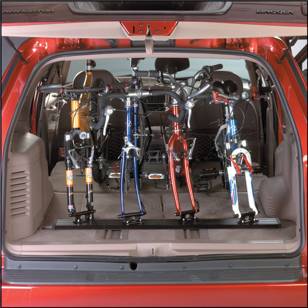 Three road bikes loaded in Saris Traps TRK33/TRK34 triple track truck bed carrier