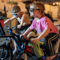 Child riding bike with Saris small wheel trainer adapter