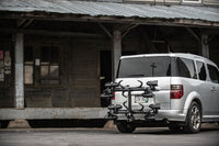 Saris SuperClamp G3 4-Bike Hitch Rack — cable lock securing all four bikes